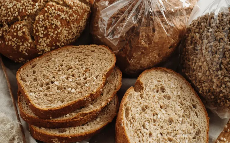 تفاوتها، شباهتها و فواید نان سبوسدار و نان جو 5 نان سبوسدار و نان جو تازه برشخورده در کیسههای پارچهای و پلاستیکی